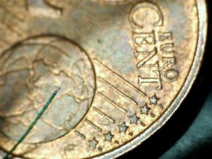 50 AWG micro-coax laser stripped on US cent background
