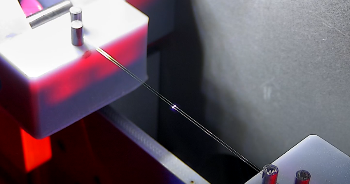 pre-stripped wire spool to spool laser wire stripping for medical devices